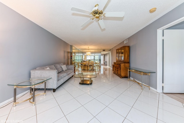 15324 Lakes Of Delray Blvd Unit 210, Delray Beach, FL 33484 - living area featuring a ceiling fan, a textured ceiling, and light tile patterned floors