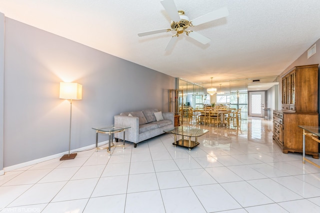 15324 Lakes Of Delray Blvd Unit 210, Delray Beach, FL 33484 - living area with ceiling fan, light tile patterned floors, and a textured ceiling