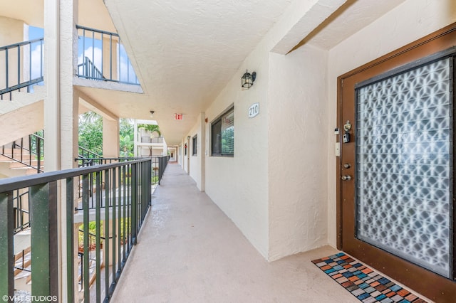 15324 Lakes Of Delray Blvd Unit 210, Delray Beach, FL 33484 - property entrance with stucco siding and a balcony