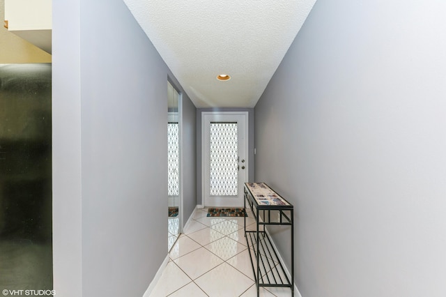15324 Lakes Of Delray Blvd Unit 210, Delray Beach, FL 33484 - doorway to outside featuring light tile patterned floors, a textured ceiling, and recessed lighting