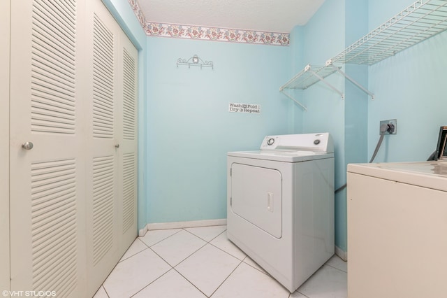 15324 Lakes Of Delray Blvd Unit 210, Delray Beach, FL 33484 - washroom featuring washing machine and clothes dryer and light tile patterned flooring