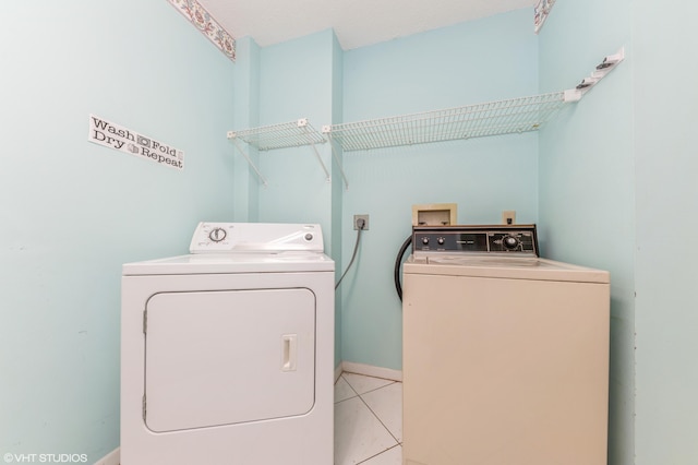 15324 Lakes Of Delray Blvd Unit 210, Delray Beach, FL 33484 - laundry room with washer and clothes dryer and light tile patterned flooring
