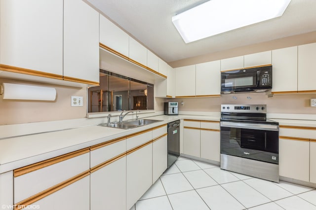15324 Lakes Of Delray Blvd Unit 210, Delray Beach, FL 33484 - kitchen with black appliances, light countertops, and light tile patterned flooring