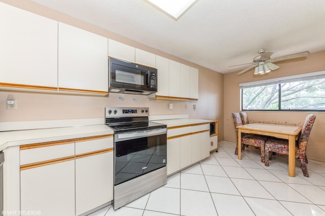 15324 Lakes Of Delray Blvd Unit 210, Delray Beach, FL 33484 - kitchen with black microwave, electric range, light countertops, white cabinetry, and ceiling fan