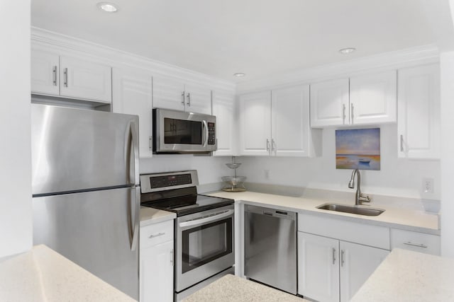 735 Monaco P, Delray Beach, FL 33446 - kitchen featuring appliances with stainless steel finishes, a sink, white cabinets, light countertops, and recessed lighting