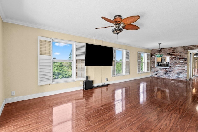 1040 Banyan Rd Unit 501C, Boca Raton, FL 33432 - unfurnished living room featuring ceiling fan, ornamental molding, wood finished floors, baseboards, and brick wall