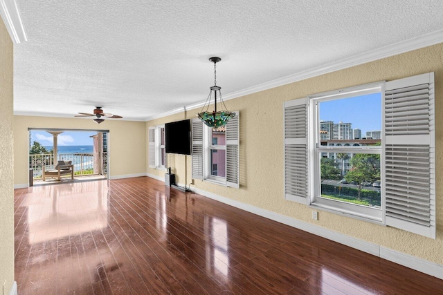 1040 Banyan Rd Unit 501C, Boca Raton, FL 33432 - unfurnished living room featuring a textured ceiling, a textured wall, baseboards, wood finished floors, and ceiling fan