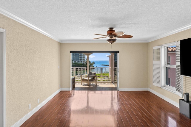 1040 Banyan Rd Unit 501C, Boca Raton, FL 33432 - spare room featuring a textured wall, a textured ceiling, hardwood / wood-style floors, crown molding, and ceiling fan