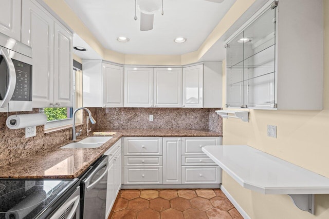 1040 Banyan Rd Unit 501C, Boca Raton, FL 33432 - kitchen with stainless steel appliances, white cabinets, a sink, and recessed lighting