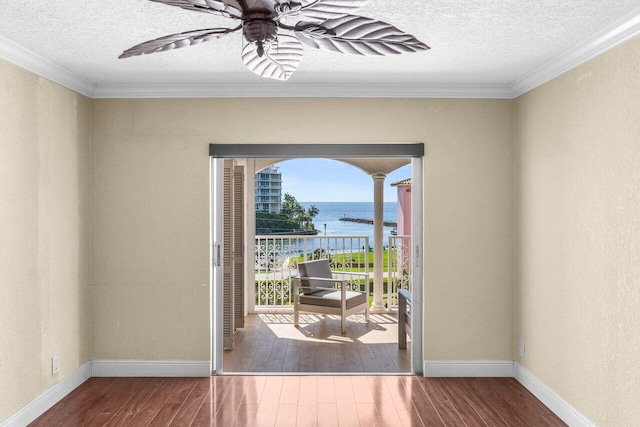 1040 Banyan Rd Unit 501C, Boca Raton, FL 33432 - doorway featuring a water view, wood-type flooring, a textured ceiling, ceiling fan, and crown molding