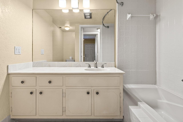 1040 Banyan Rd Unit 501C, Boca Raton, FL 33432 - full bathroom featuring vanity,  shower combination, and a textured wall