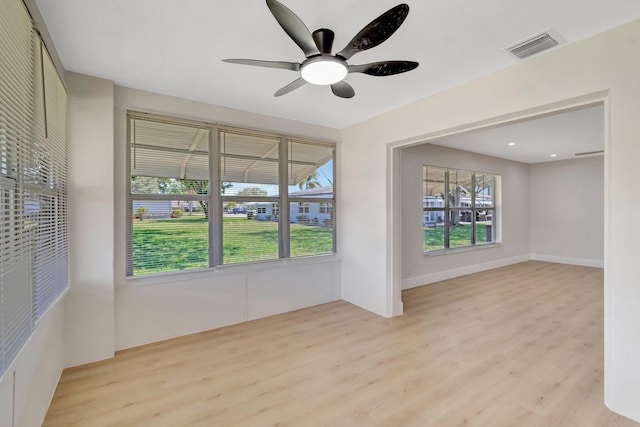 empty room with light wood-type flooring and a ceiling fan