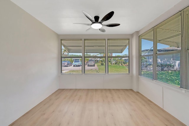 unfurnished sunroom with wood finished floors and ceiling fan