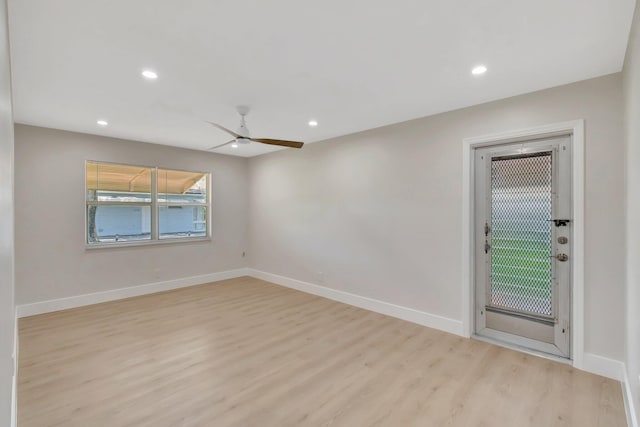 empty room featuring light wood-type flooring, recessed lighting, a ceiling fan, and baseboards