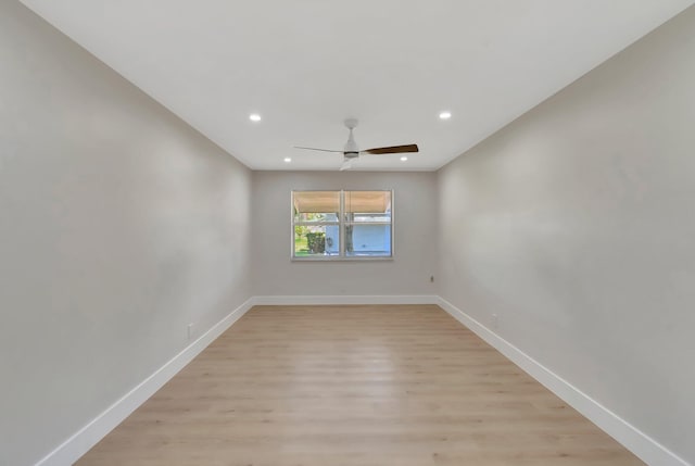 empty room with a ceiling fan, light wood finished floors, baseboards, and recessed lighting