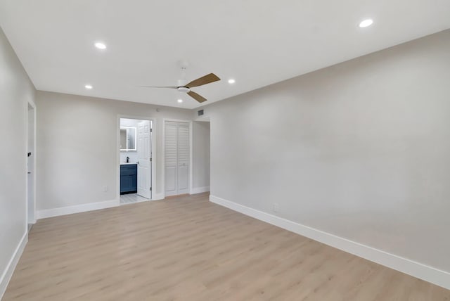unfurnished living room featuring a ceiling fan, baseboards, light wood-style flooring, and recessed lighting