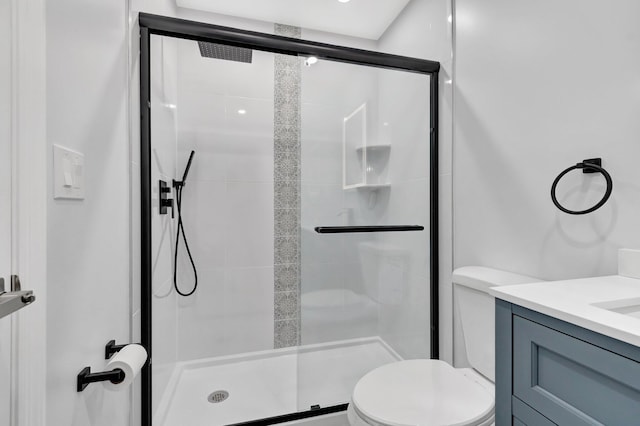 full bath featuring a shower stall, toilet, and vanity