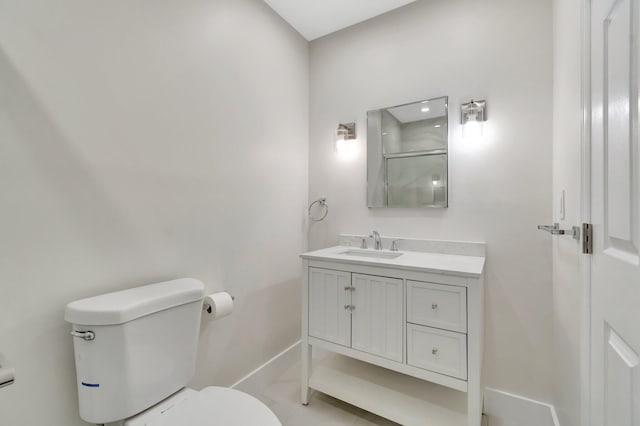 bathroom with toilet, a shower with shower door, baseboards, and vanity