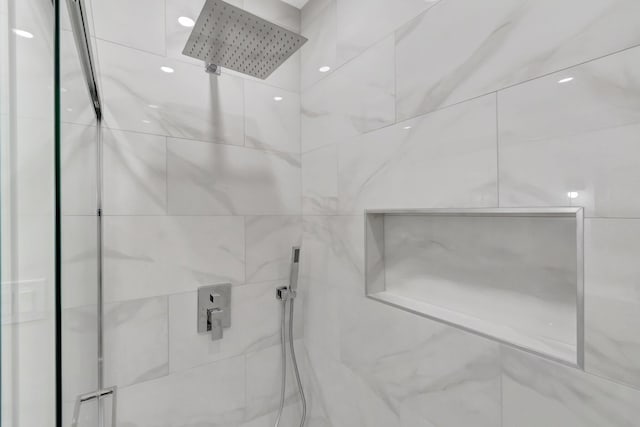 bathroom with a marble finish shower