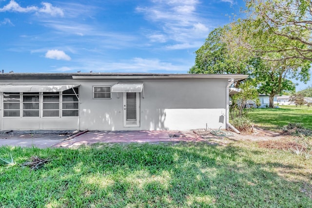 470 High Point Dr Unit A, Delray Beach, FL 33445 - back of house featuring a yard, stucco siding, and a patio area