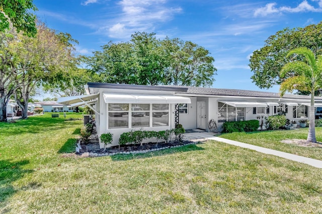 view of front of house featuring a front yard and stucco siding
