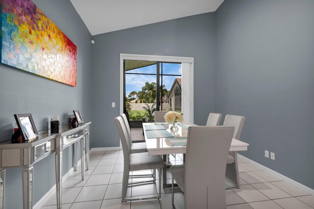 10393 Lexington Cir S, Boynton Beach, FL 33436 - dining room with lofted ceiling, light tile patterned floors, and baseboards