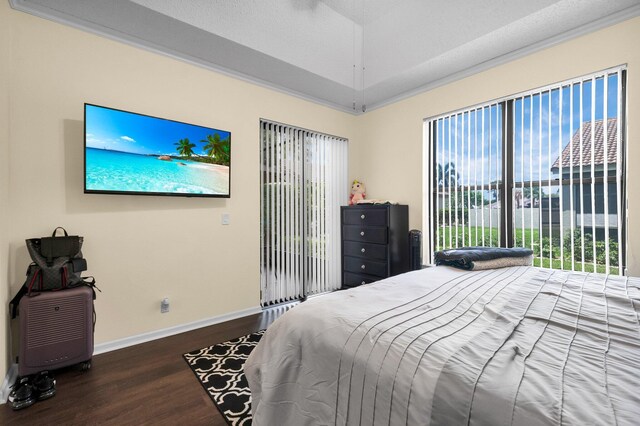 10393 Lexington Cir S, Boynton Beach, FL 33436 - bedroom with wood finished floors, baseboards, a tray ceiling, and access to exterior