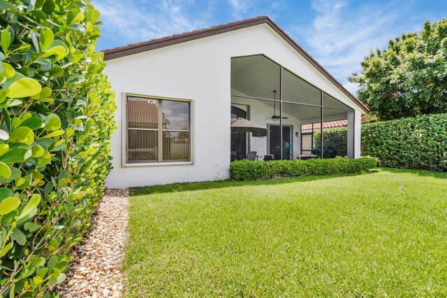 10393 Lexington Cir S, Boynton Beach, FL 33436 - rear view of property with ceiling fan, a lawn, and stucco siding
