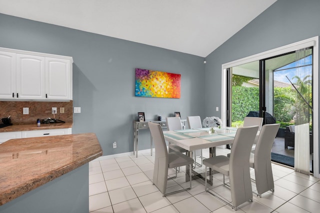 10393 Lexington Cir S, Boynton Beach, FL 33436 - dining area featuring vaulted ceiling, light tile patterned floors, and baseboards