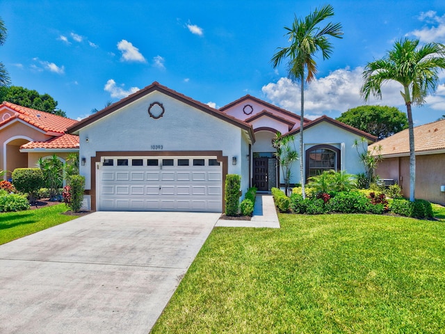10393 Lexington Cir S, Boynton Beach, FL 33436 - mediterranean / spanish home with an attached garage, stucco siding, a front lawn, and concrete driveway