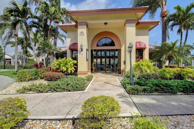 10393 Lexington Cir S, Boynton Beach, FL 33436 - entrance to property featuring stucco siding and french doors