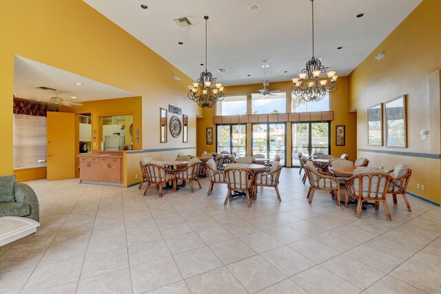10393 Lexington Cir S, Boynton Beach, FL 33436 - dining room with a chandelier, light tile patterned floors, a high ceiling, and recessed lighting