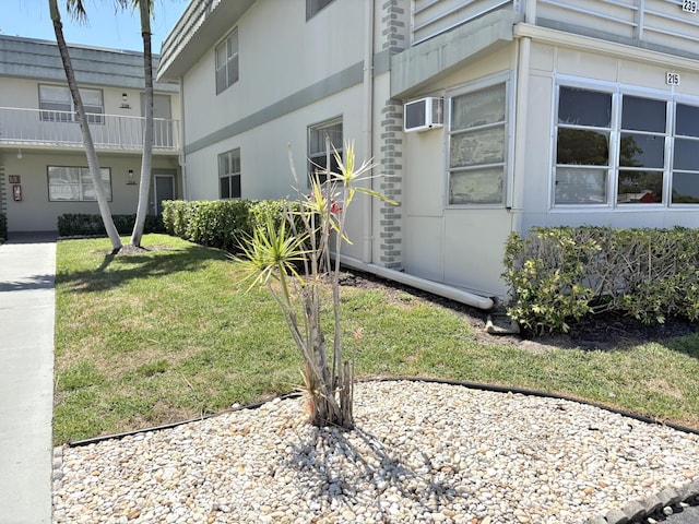 215 Monaco E, Delray Beach, FL 33446 - view of property exterior featuring a yard and an AC wall unit