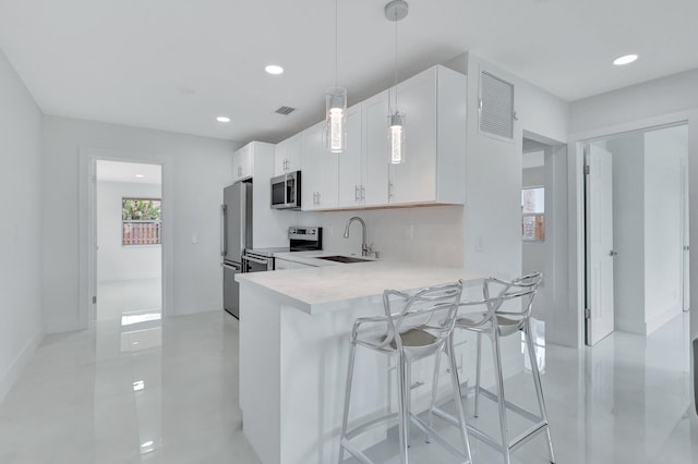 5305 Cleveland Rd, Delray Beach, FL 33484 - kitchen with appliances with stainless steel finishes, a sink, light countertops, recessed lighting, and white cabinets