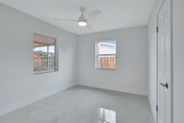 5305 Cleveland Rd, Delray Beach, FL 33484 - unfurnished bedroom featuring baseboards, light tile patterned flooring, and ceiling fan