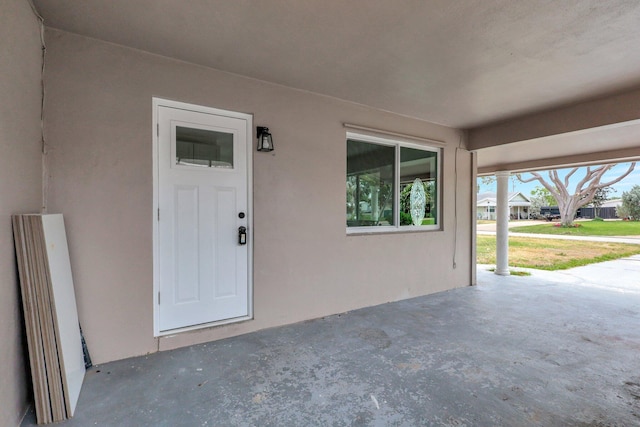 5305 Cleveland Rd, Delray Beach, FL 33484 - view of exterior entry featuring stucco siding and a patio area