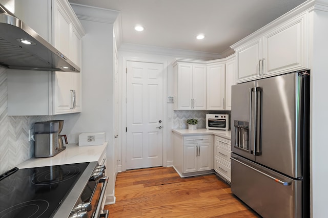 4608 Cadiz Cir, Palm Beach Gardens, FL 33418 - kitchen featuring appliances with stainless steel finishes, wall chimney range hood, light countertops, white cabinets, and recessed lighting