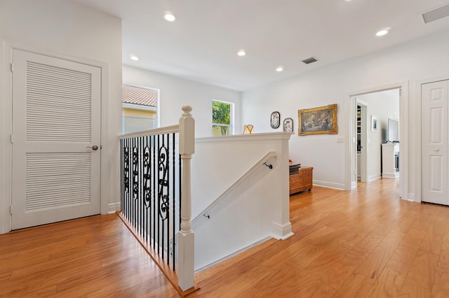 4608 Cadiz Cir, Palm Beach Gardens, FL 33418 - hall featuring an upstairs landing, light wood-type flooring, recessed lighting, and baseboards