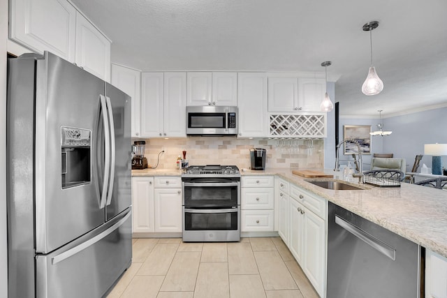 kitchen featuring stainless steel appliances, a sink, white cabinets, backsplash, and light stone counters