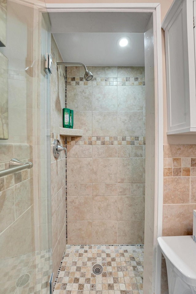 full bathroom with a shower stall, toilet, and recessed lighting