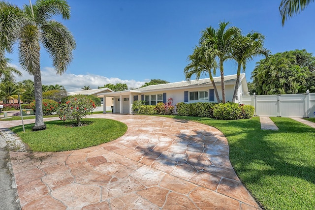 single story home featuring a garage, curved driveway, a gate, and stucco siding