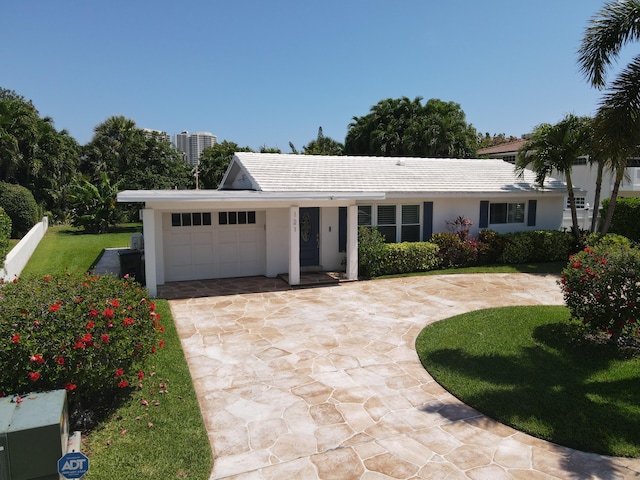 ranch-style house with an attached garage, curved driveway, stucco siding, and a tile roof