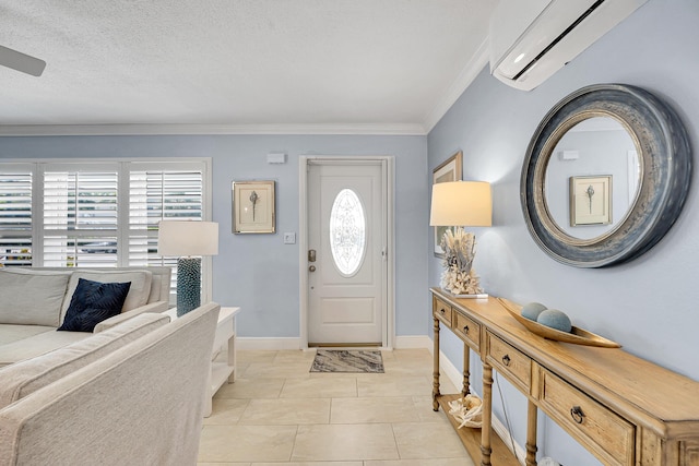 entryway with a wall unit AC, ornamental molding, baseboards, and light tile patterned floors