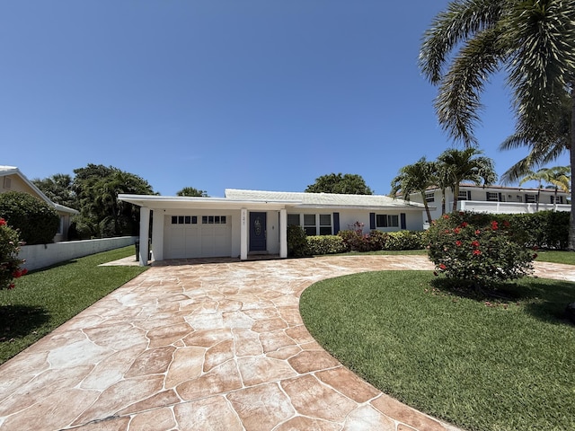 ranch-style home featuring a garage, driveway, and stucco siding
