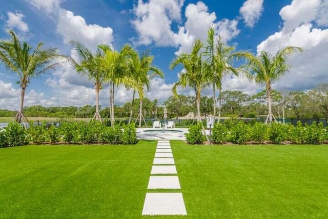 view of grassy yard with a swimming pool