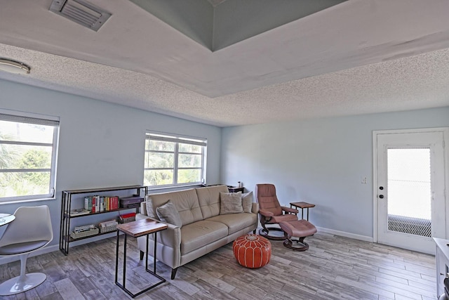 2950 SE Ocean Blvd Unit 127-8, Stuart, FL 34996 - living room featuring wood finished floors, a textured ceiling, and baseboards