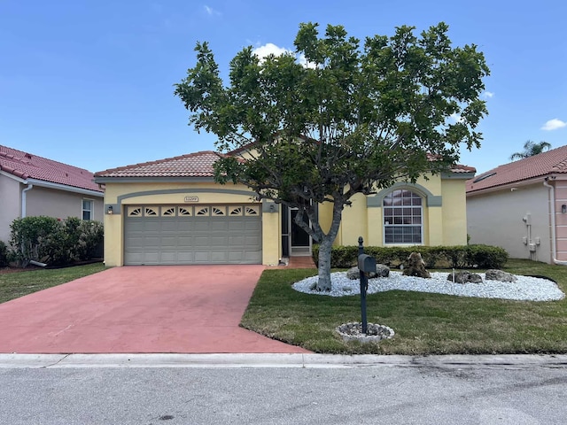 12299 Wedge Way, Boynton Beach, FL 33437 - mediterranean / spanish-style house featuring stucco siding, a garage, a front yard, and driveway
