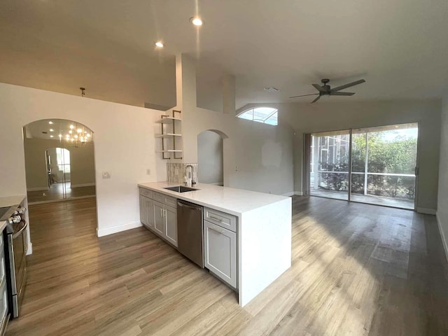 12299 Wedge Way, Boynton Beach, FL 33437 - kitchen with arched walkways, stainless steel appliances, a sink, a ceiling fan, and open floor plan