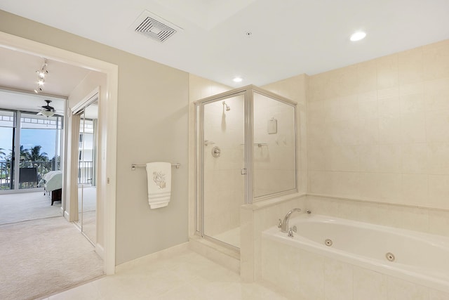 230 Ocean Grande Blvd Unit 501, Jupiter, FL 33477 - full bathroom with ensuite bath, a jetted tub, a stall shower, a ceiling fan, and tile patterned flooring