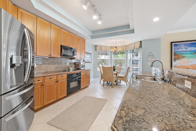 230 Ocean Grande Blvd Unit 501, Jupiter, FL 33477 - kitchen with black appliances, a sink, a chandelier, tasteful backsplash, and stone counters